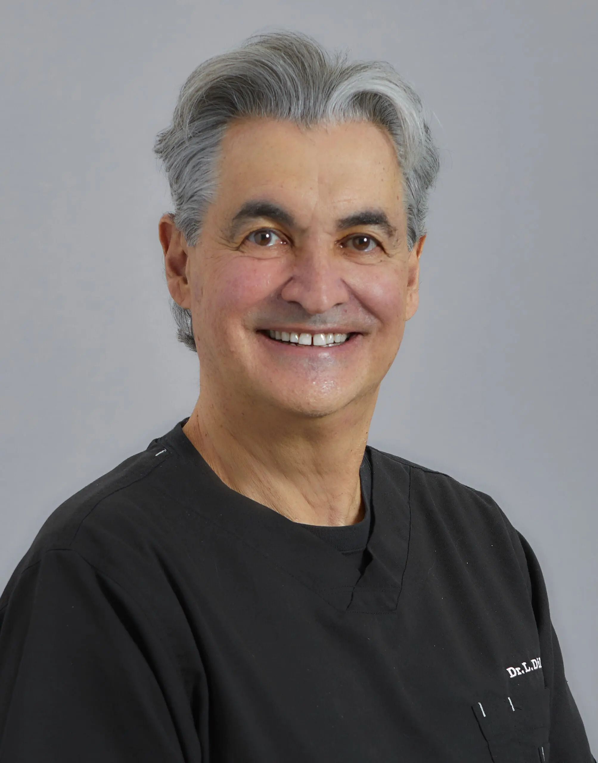 A photo of Dr. Leonard Di Paolo, a general dentist, smiling warmly.