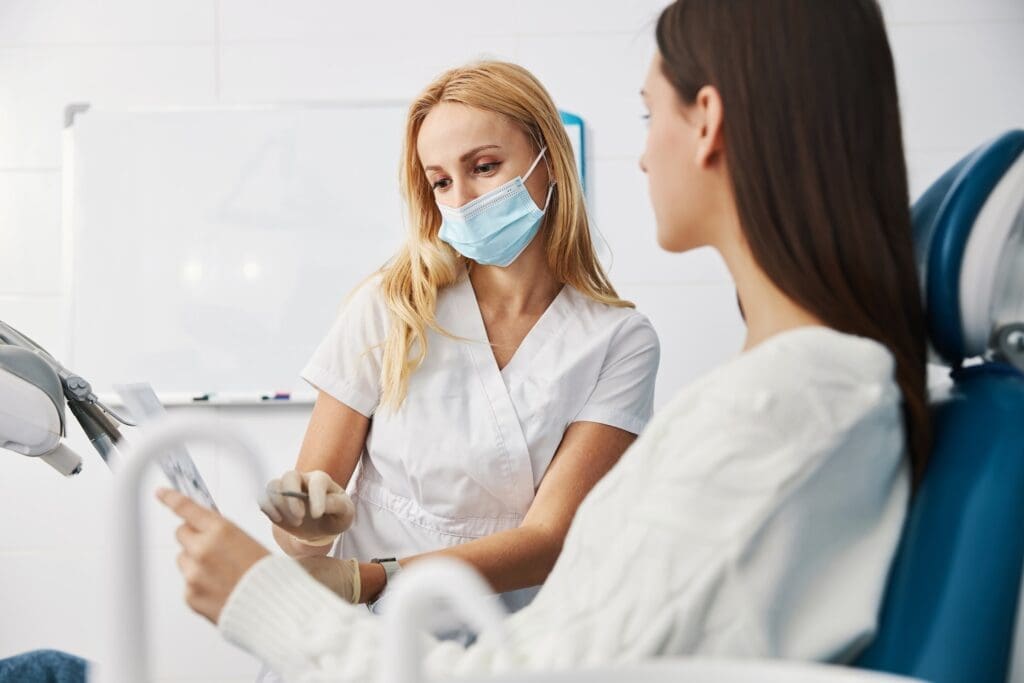 A patient discussing root canal treatment with a dentist at Waban Dental Group in Newton, MA.