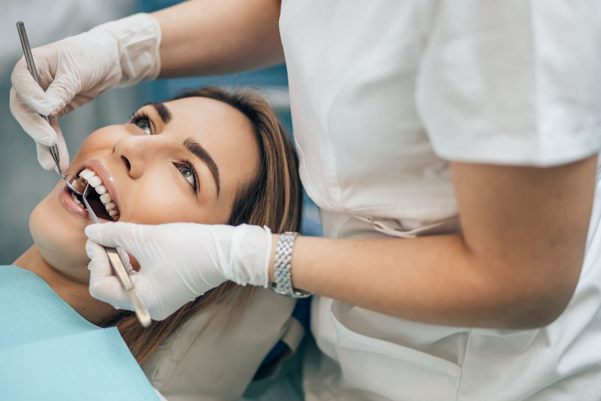 An individual smiling, showcasing the connection between oral health and overall wellness.