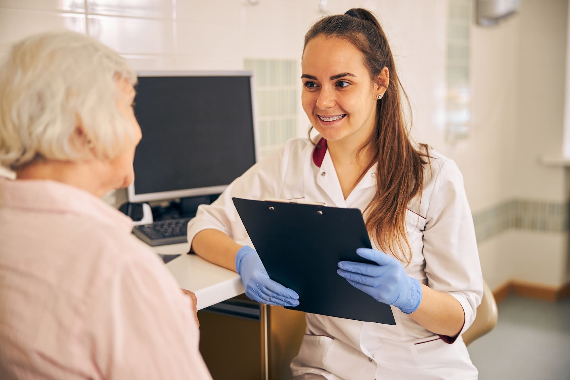 A person reading a modern guide to orthodontic treatment at Waban Dental Group in Newton, MA.