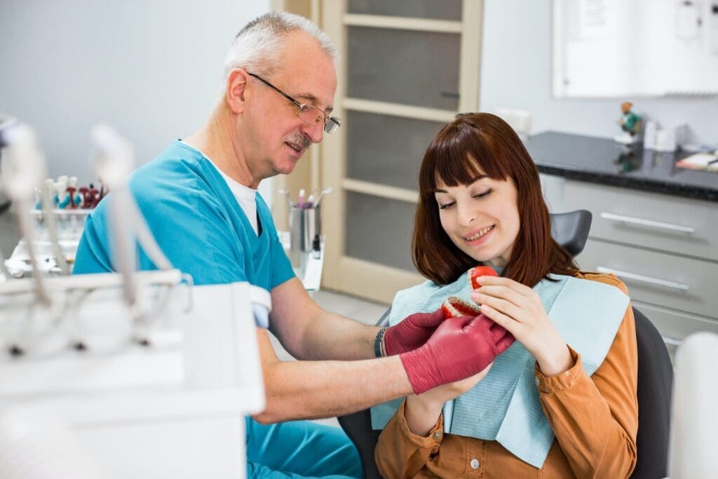 A person reading about dental implants at Waban Dental Group in Newton, MA.