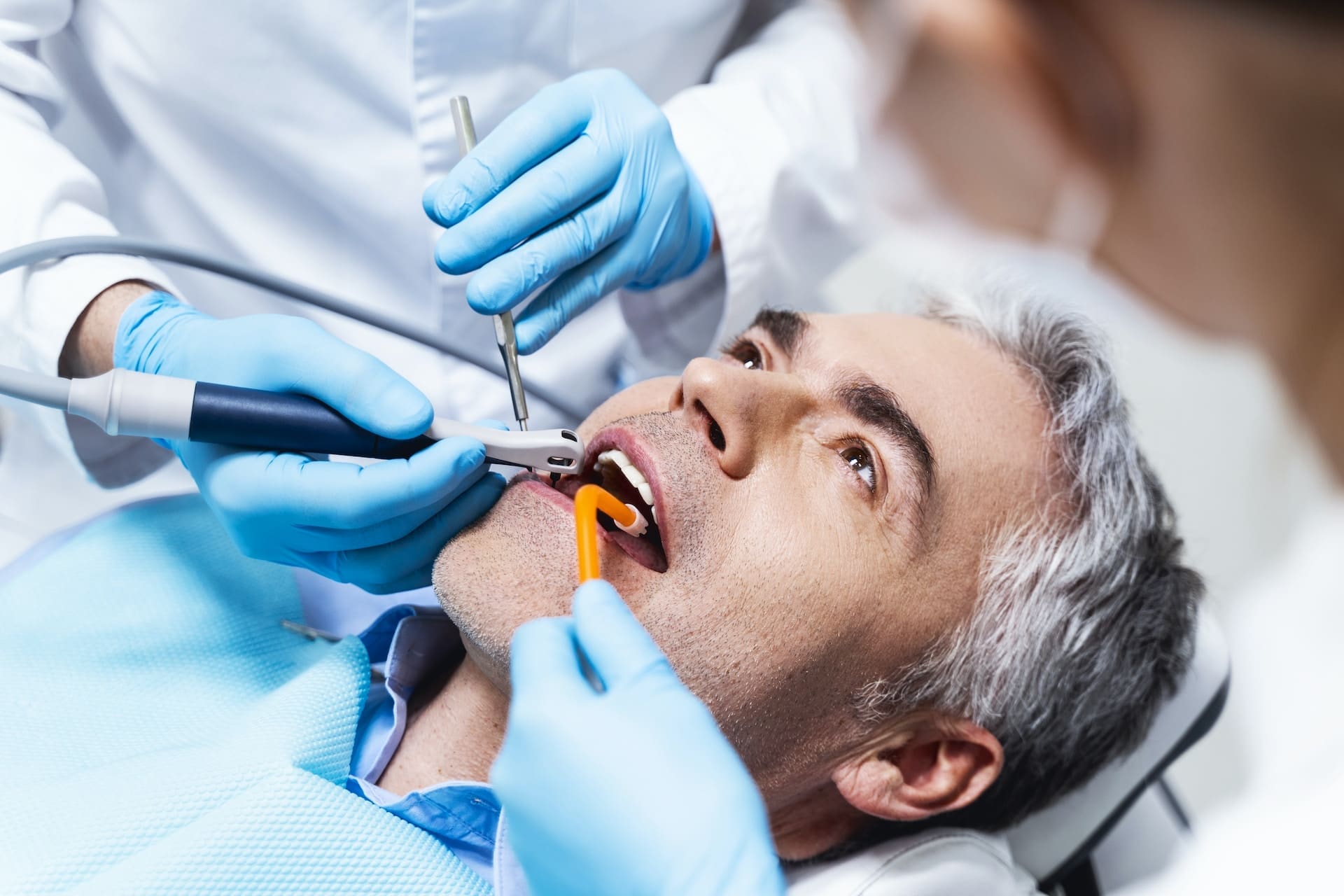 A busy individual receiving dental care advice from a dentist at Waban Dental Group in Newton, MA.