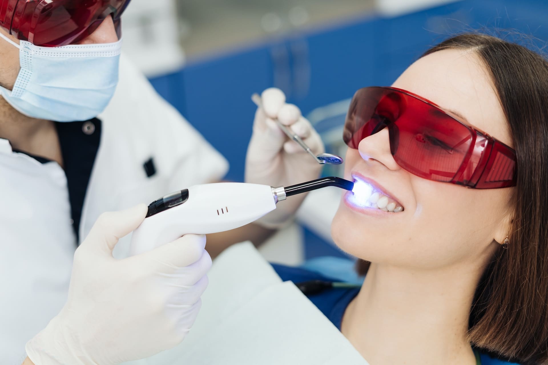 A person smiling confidently after receiving cosmetic orthodontic solutions at Waban Dental Group in Newton, MA.