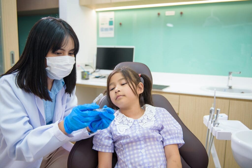 A family practicing healthy dental habits together at Waban Dental Group in Newton, MA."