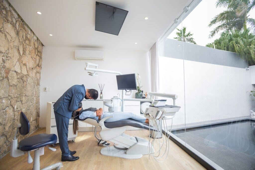 A person discussing important questions with their dentist at Waban Dental Group in Newton, MA.