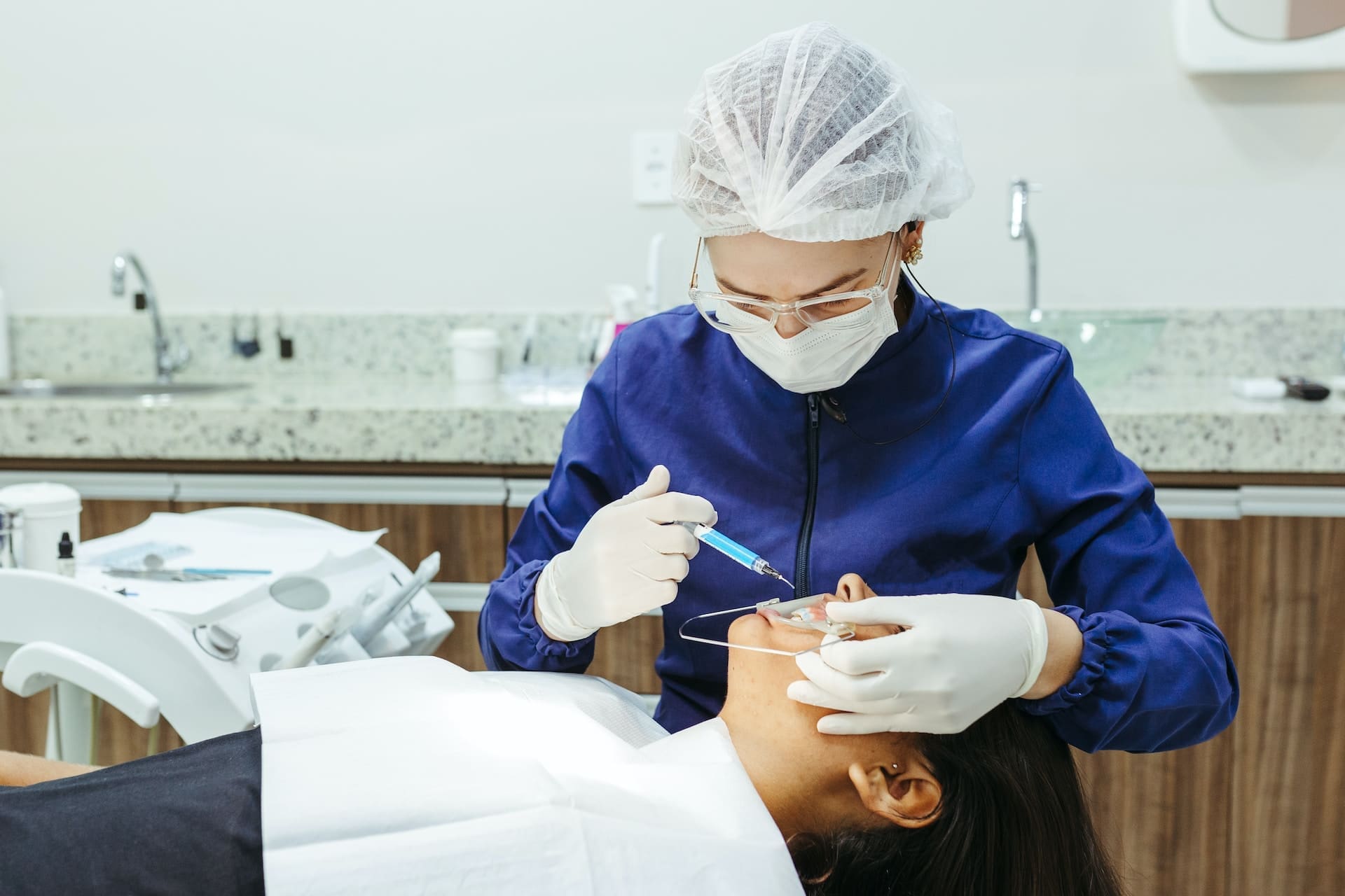 A person reading a preventative dental care guide at Waban Dental Group in Newton, MA.