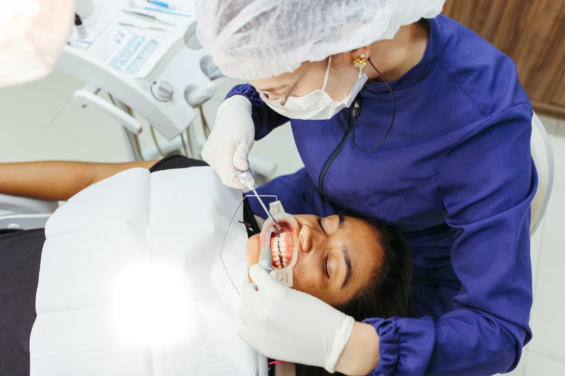 A pregnant woman discussing dental health with a dentist at Waban Dental Group in Newton, MA.