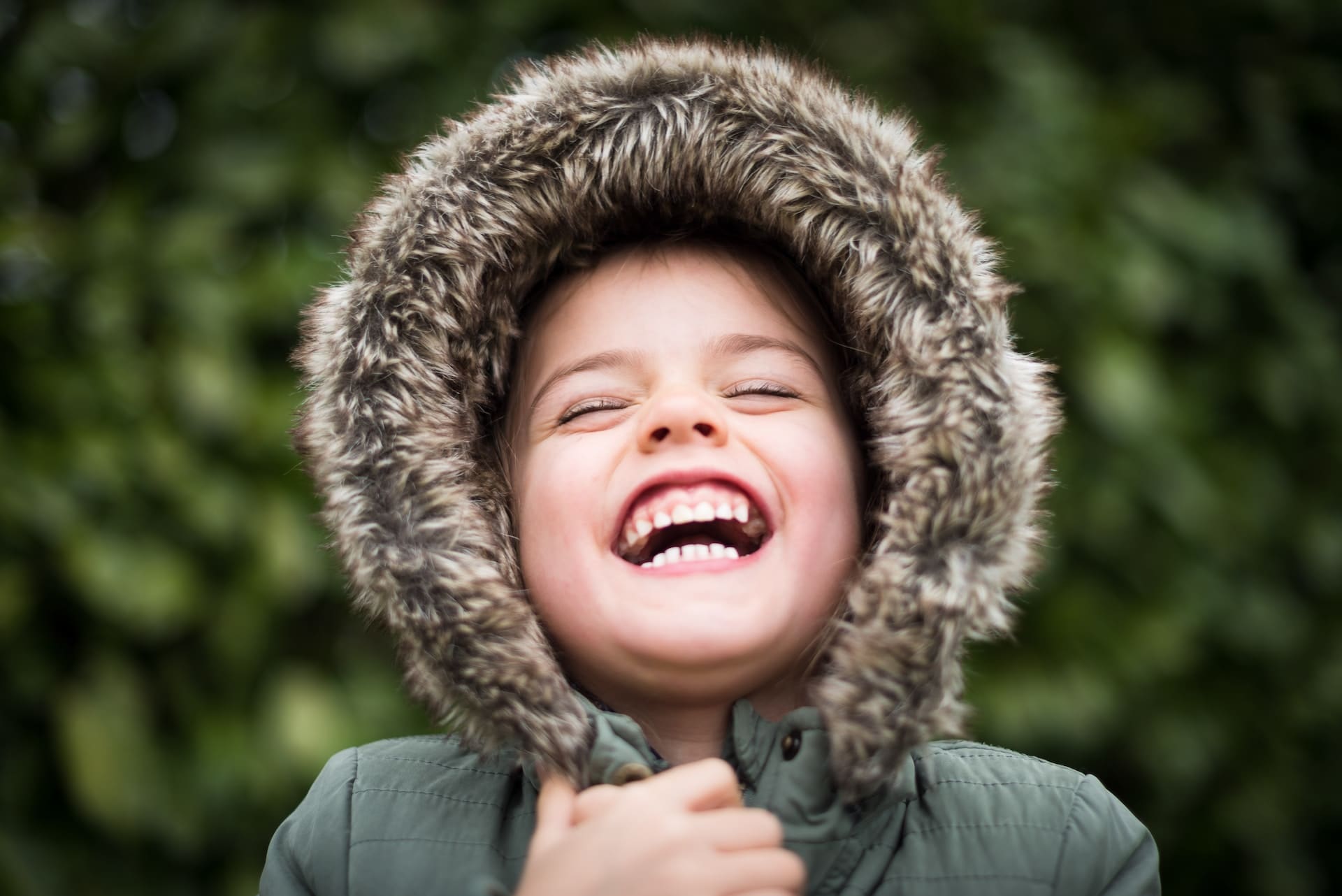 A child is laughing after a fluoride treatment at Waban Dental Group in Newton, MA. This positive reaction shows that fluoride treatments can be a fun and comfortable experience for kids!