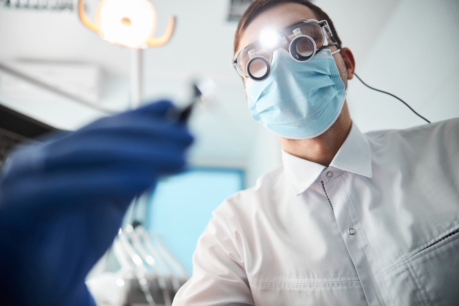 A dentist providing emergency dental care to a patient, demonstrating effective crisis management in dentistry.