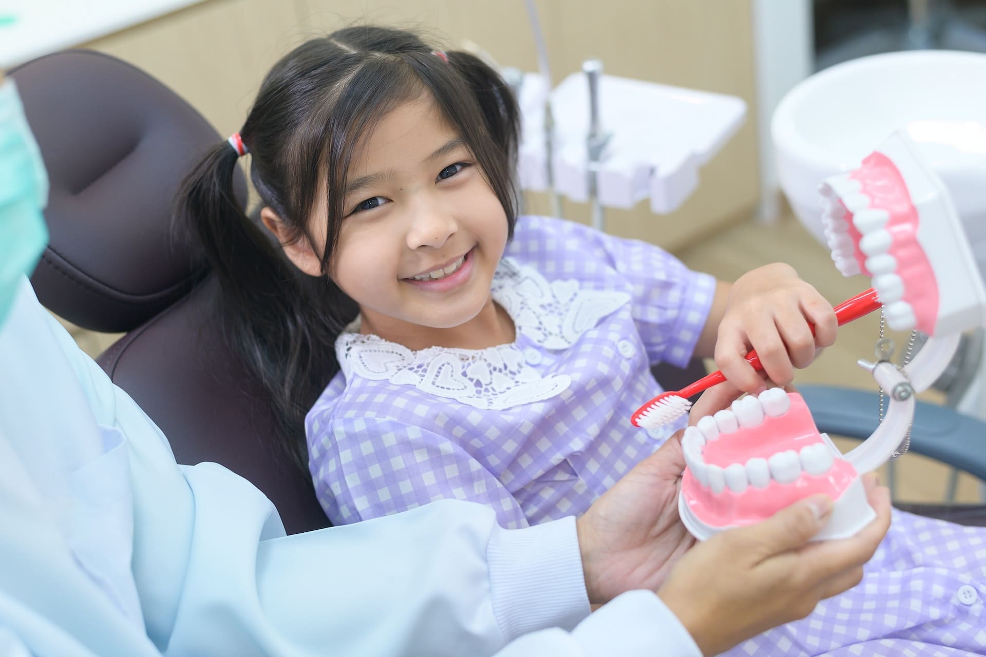 A parent discussing pulp therapy options with a pediatric dentist at Waban Dental Group in Newton, MA.