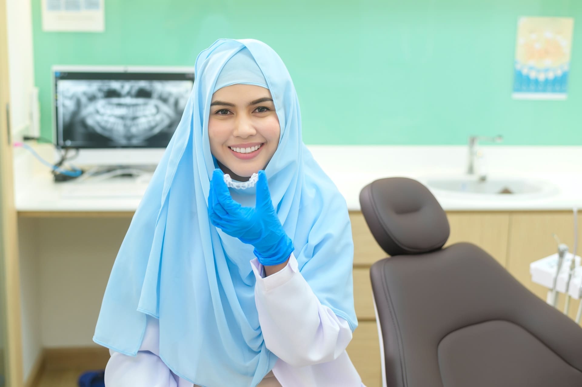 An adult smiling while wearing Invisalign aligners, appreciating the discreet nature of their orthodontic treatment.