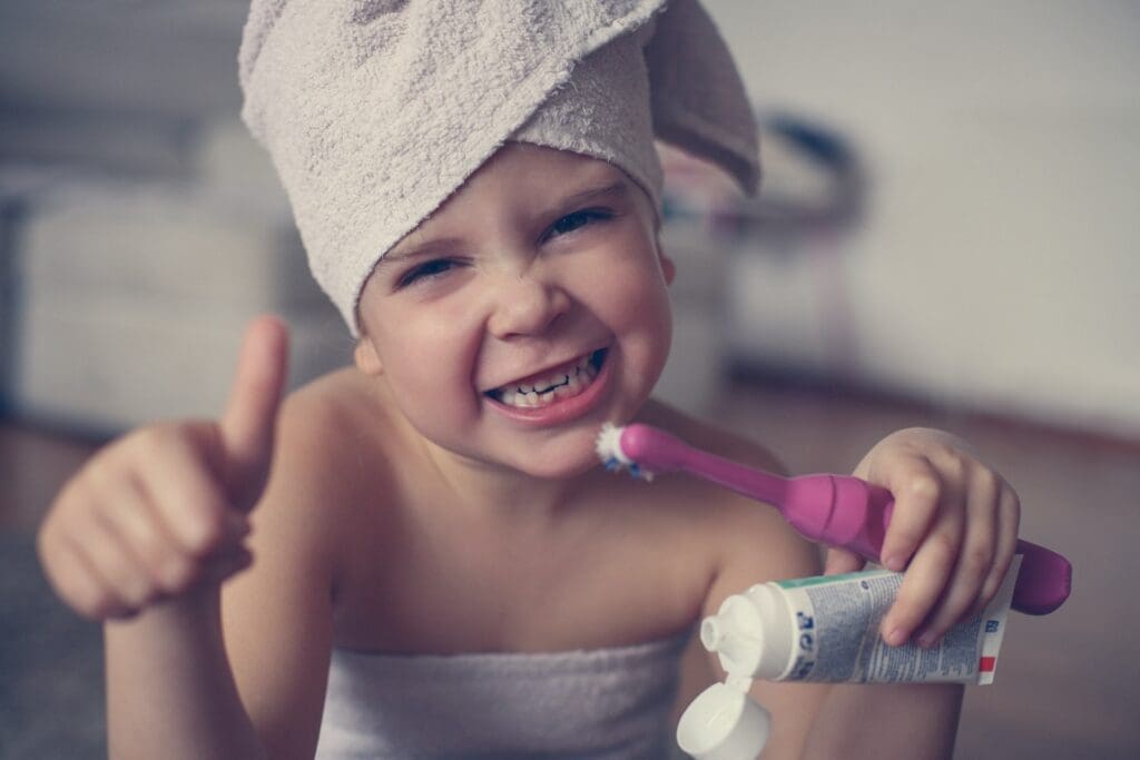 A child laughing and feeling at ease during a dental visit, thanks to strategies that reduce dental anxiety.