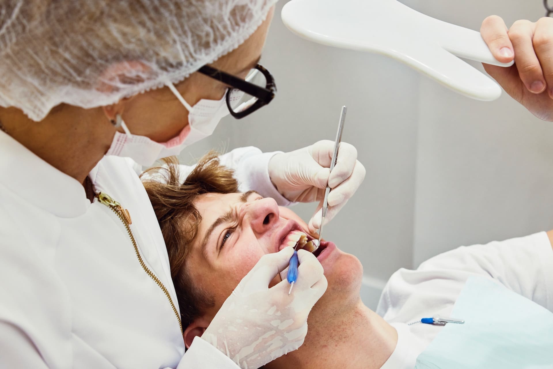 A patient receiving emergency dental care from the prompt and professional team at Waban Dental Group.