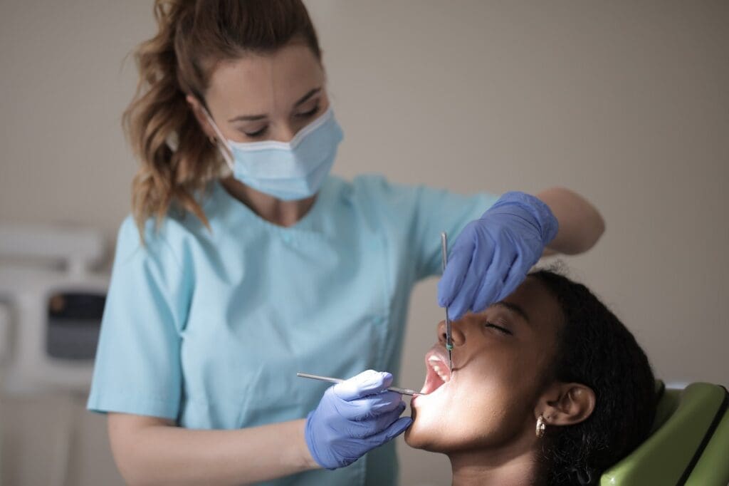 A patient getting a dental treatment, emphasizing the importance of regular dental exams for maintaining oral health.