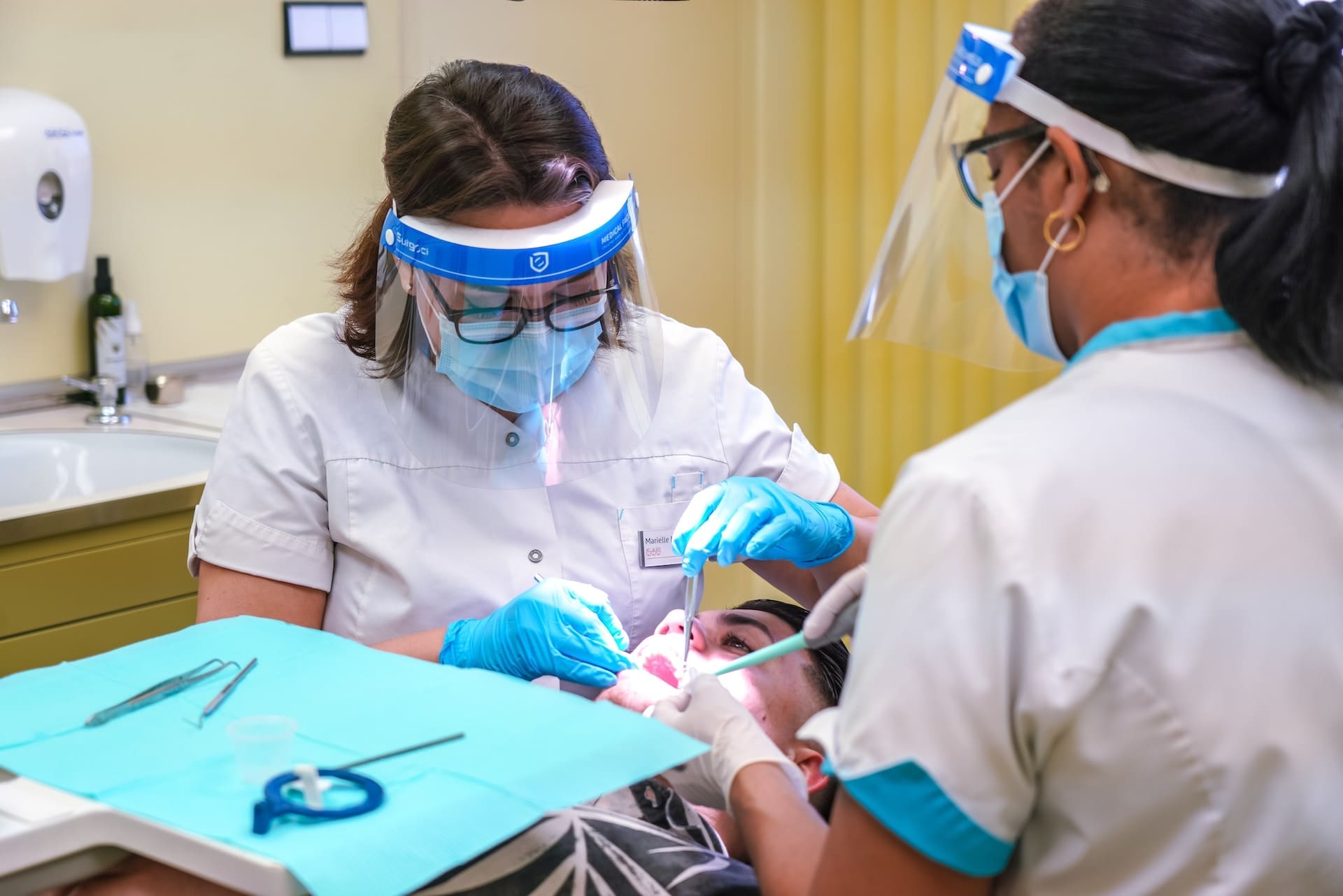 A dentist applying dental sealants to a patient's teeth, effectively preventing tooth decay, in a clinic in Newton, MA.