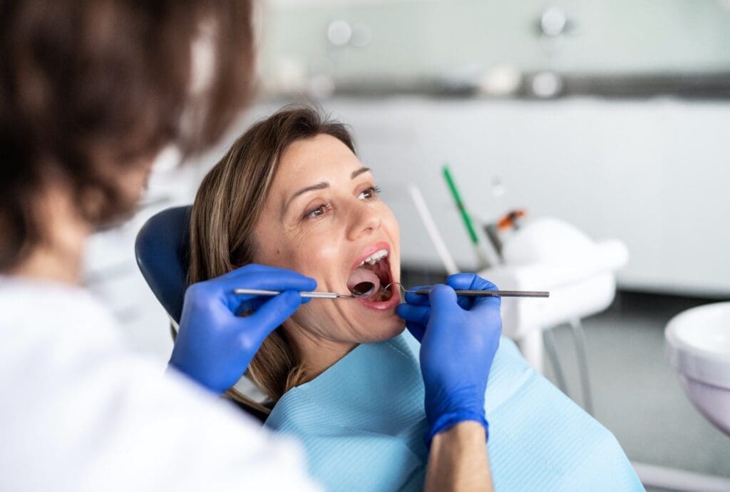 A patient discussing dental crown options with the best dentist in Newton, MA, in preparation for the procedure.