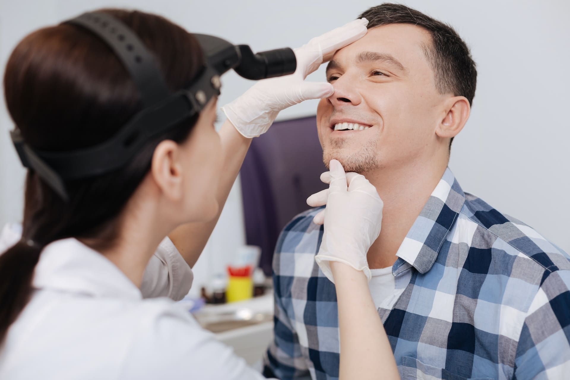 A person consulting with the best dentist in Newton, MA, to choose the ideal teeth whitening option.