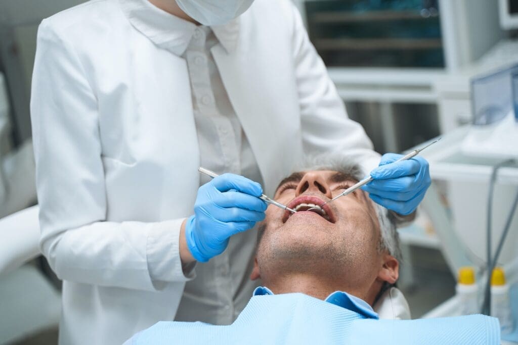 An adult discussing orthodontic options with the best dentist in Newton, MA, showcasing the range of treatments available.