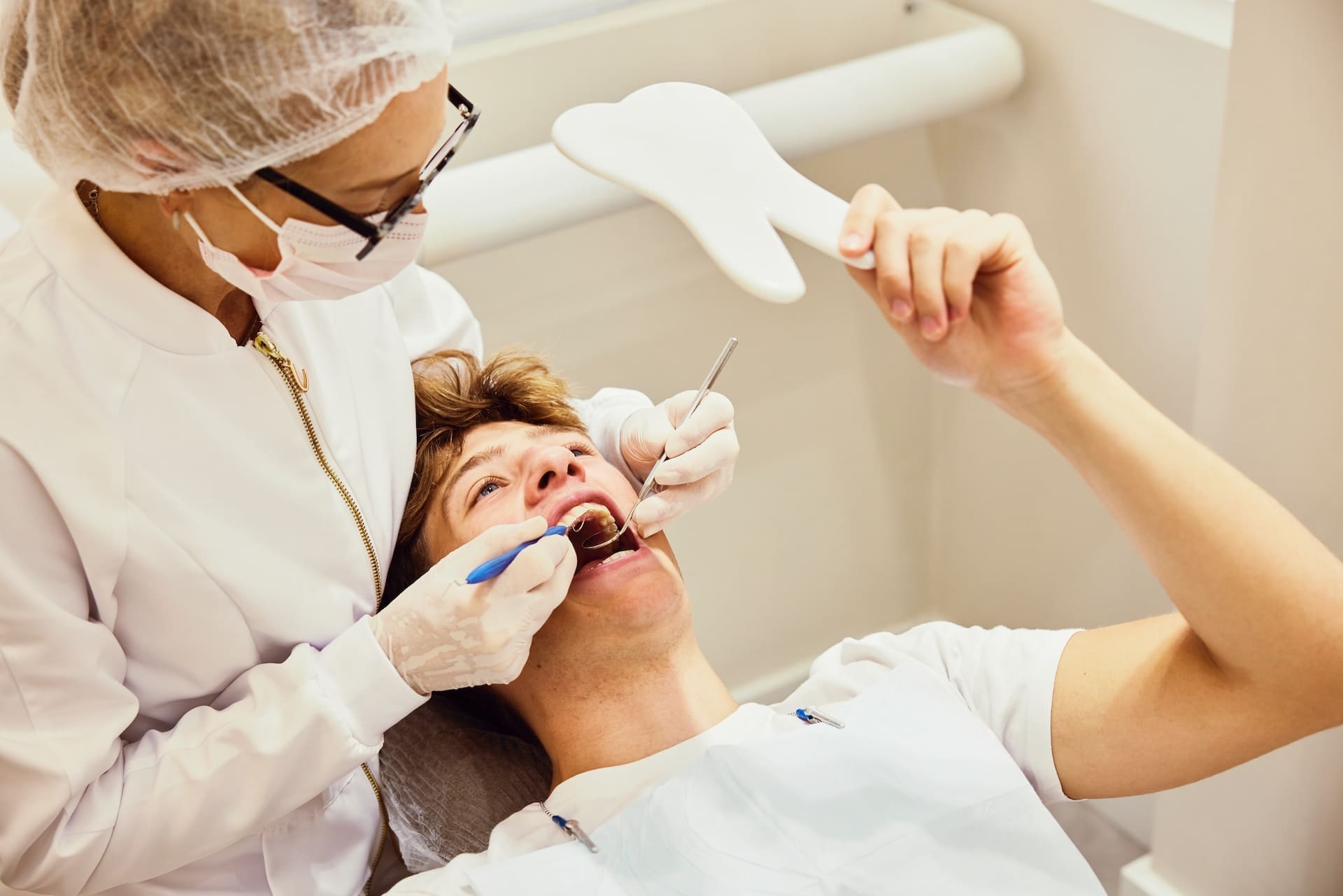 A patient receiving a comprehensive dental exam from the best dentist in Newton, MA, highlighting the practice of preventive dentistry.