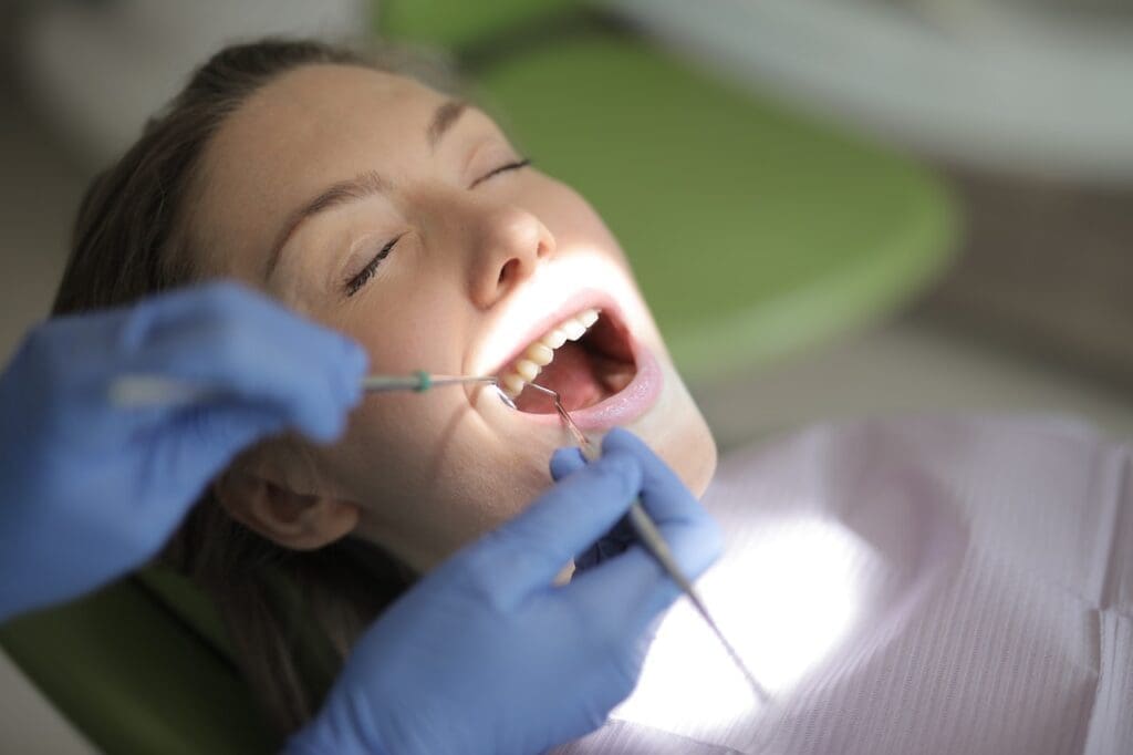 A patient feeling at ease during a dental visit, thanks to anxiety-reducing techniques employed by the best dentist in Newton, MA.