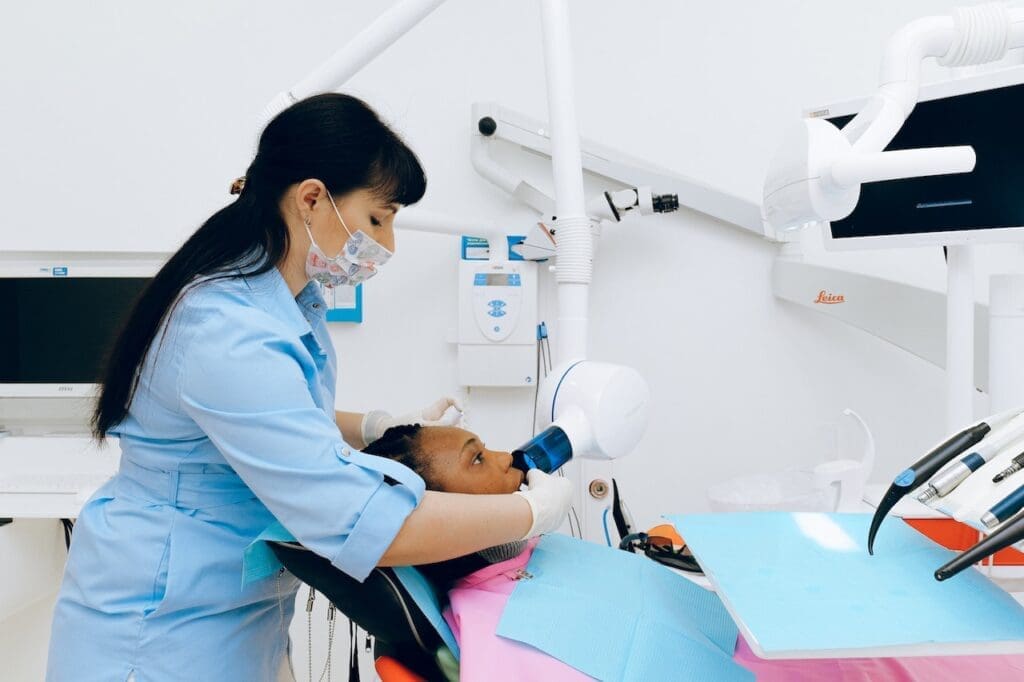 A child being fitted for a sports guard while receiving dental sealants, showcasing comprehensive smile protection in Newton, MA.