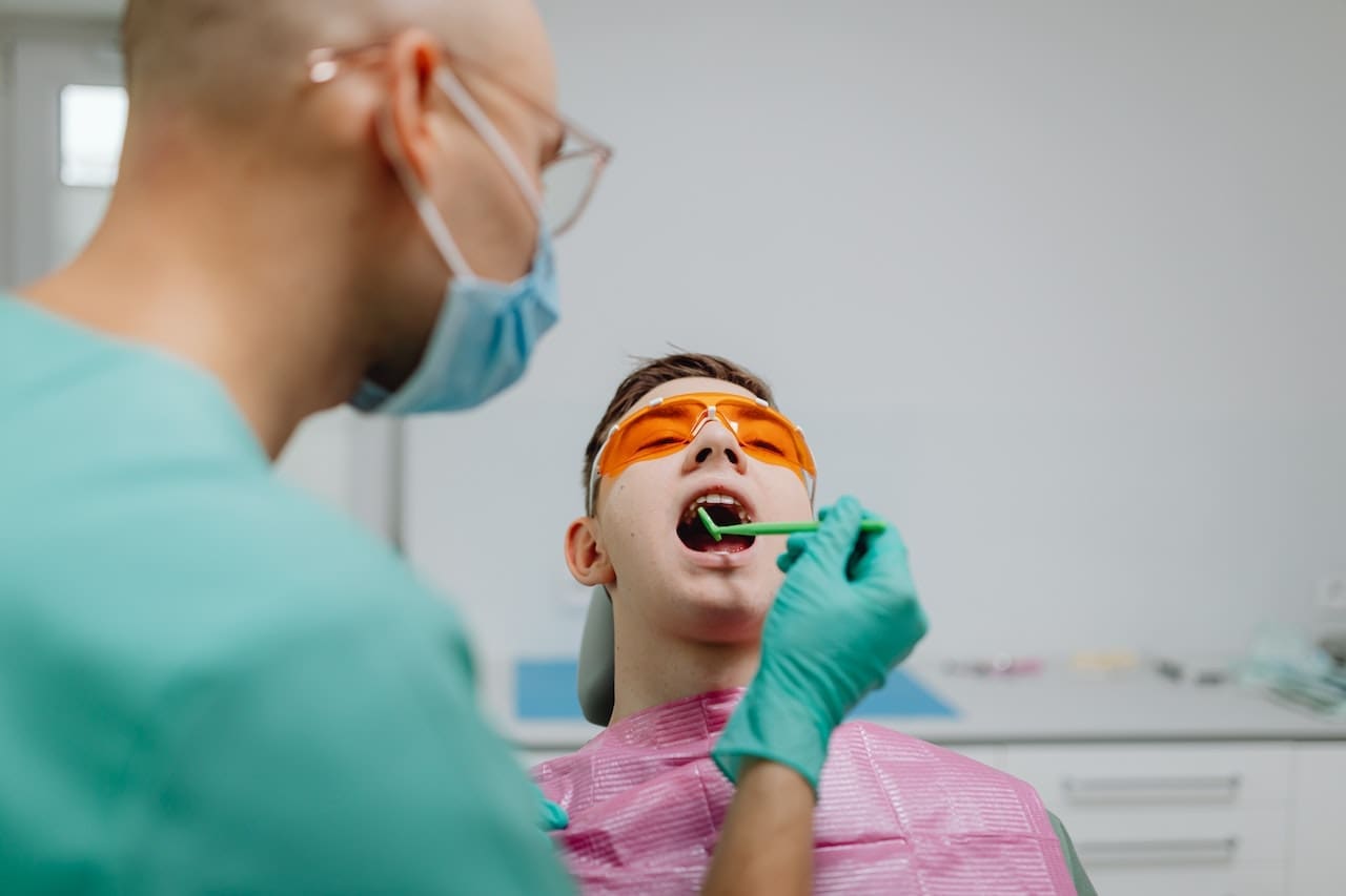 An adult patient consulting about orthodontic options for a beautiful smile at Waban Dental Group, led by Newton's top dentists.