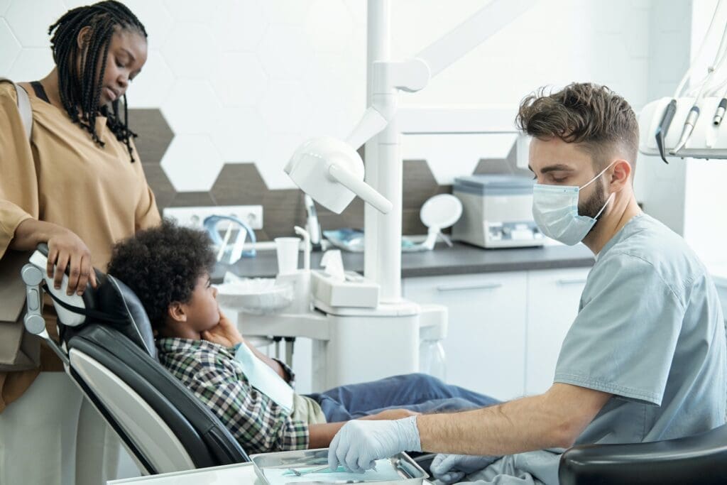 Child having their first dental exam at Waban Dental Group in Newton, MA, with a focus on a gentle and welcoming approach.