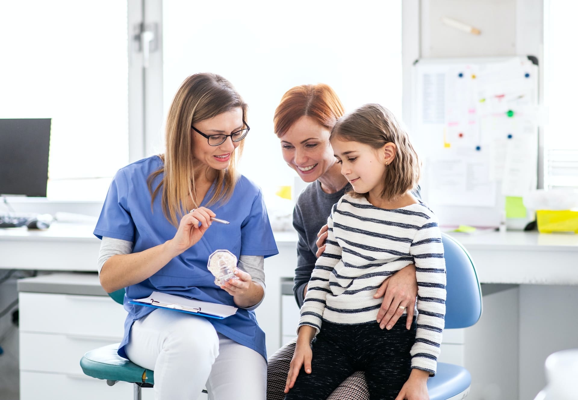 Illustration depicting a parent and child preparing for a pediatric dental exam at Waban Dental Group, Newton, MA.