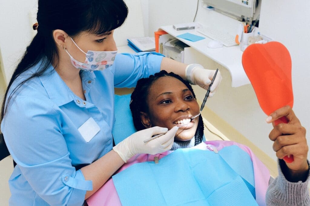 A split-image showcasing a person's smile before and after professional teeth whitening at Waban Dental Group.