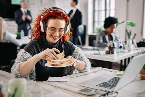 A woman eating lunch at her desk