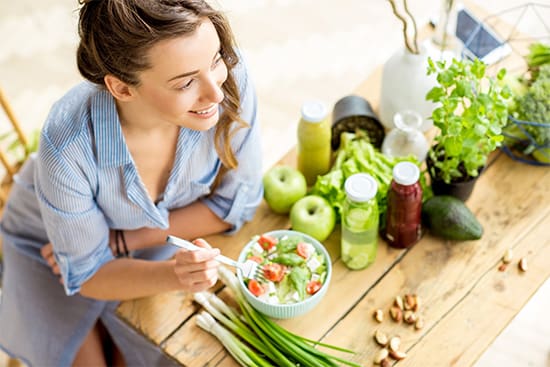 Patient in Newton eating after getting dental implants