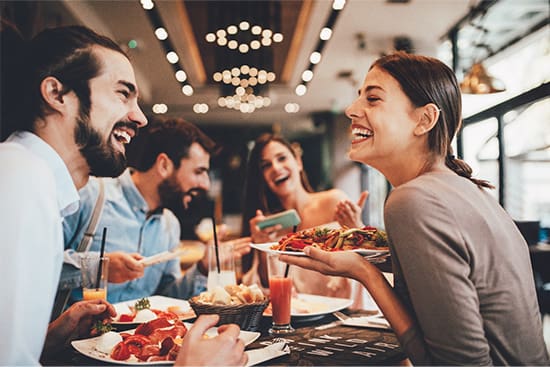 Patient in Newton hanging out with friends after getting dental implants