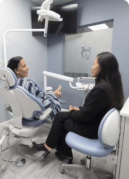 Doctor Denise Leong-Yokota converses with another woman, representing a consultation at Waban Dental Group.