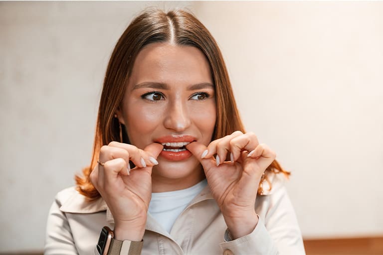 Patient putting on clear aligner in treatment room.