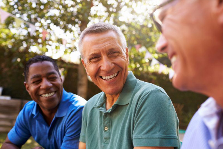 Group of senior male friends laughing together.