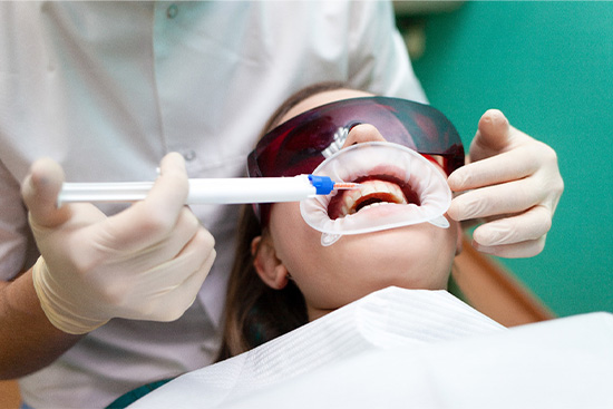 Patient having her teeth whitened.
