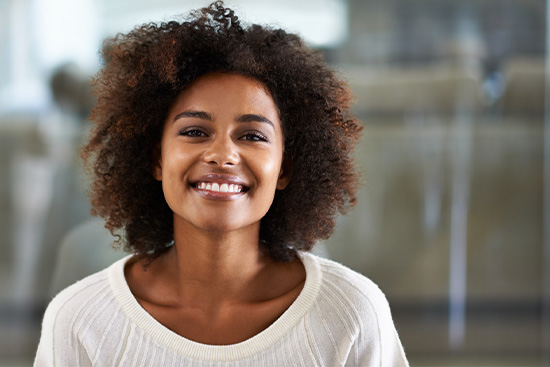 Young woman showing off beautifully whiter smile.
