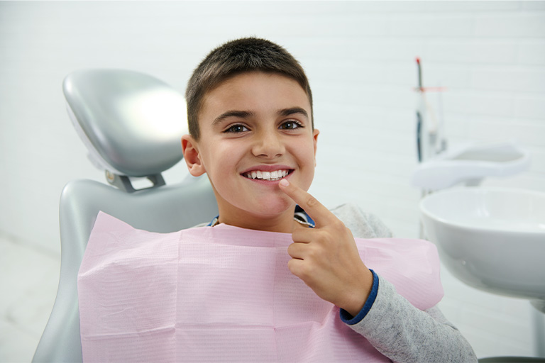 Young boy smiling at the dentist’s office.