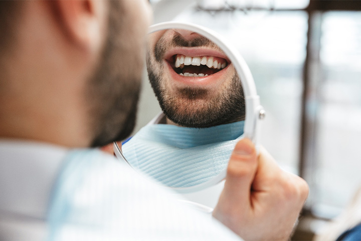 Patient looking at smile in reflection.
