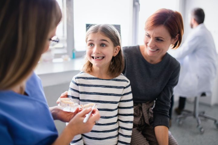 Image depicting a dentist applying dental sealants to a child's teeth at Waban Dental Group, Newton, MA, for enhanced tooth protection.